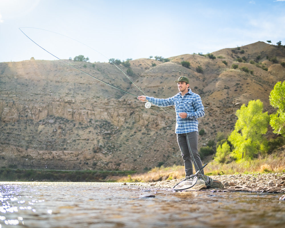 Man fly fishing outside in MuskOx Grand Flannel